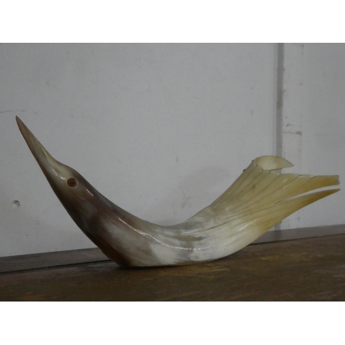 142 - A large carved horn bird, 34cm.