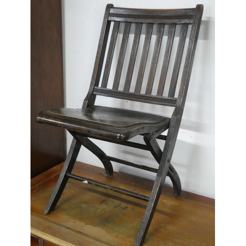 150 - An antique folding chair.