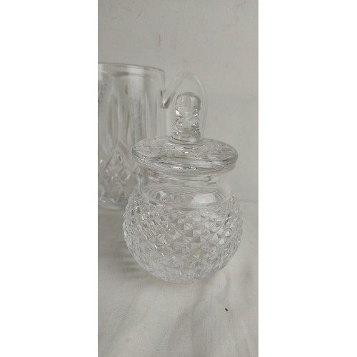 55 - An assortment of Waterford crystal to include, two jugs, a footed bowl, a lidded pot and three glass... 