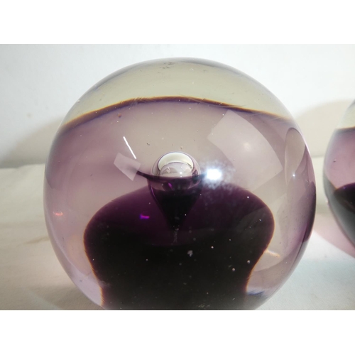 220 - A pair of vintage coloured glass paperweights.