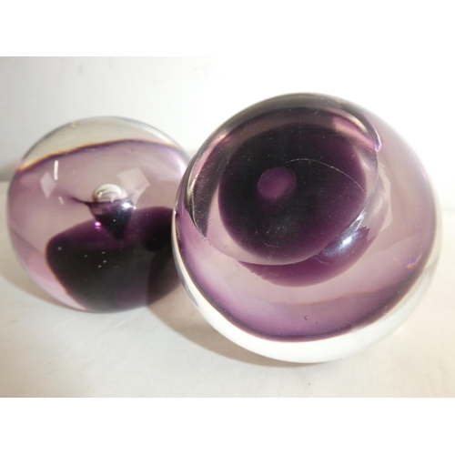 220 - A pair of vintage coloured glass paperweights.