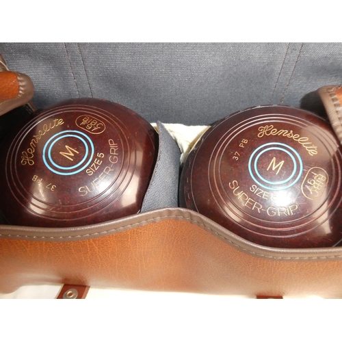 222 - A cased set of Henselite size 5 carpet bowls.