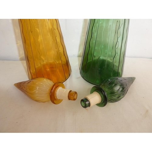 257 - Two vintage coloured glass 'Genie' bottles, each measuring 20