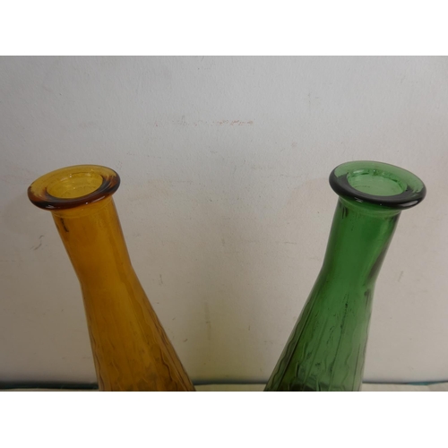 257 - Two vintage coloured glass 'Genie' bottles, each measuring 20