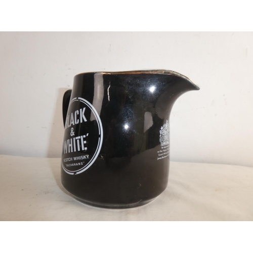 264 - A vintage Black & White whiskey jug.