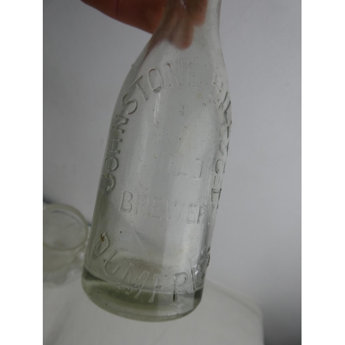 266 - A vintage clear glass demi john bottle, a Johnston Hill & Co Ltd, Dumfries beer bottle, an Old Bushm... 