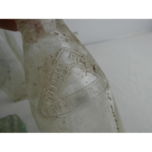 266 - A vintage clear glass demi john bottle, a Johnston Hill & Co Ltd, Dumfries beer bottle, an Old Bushm... 