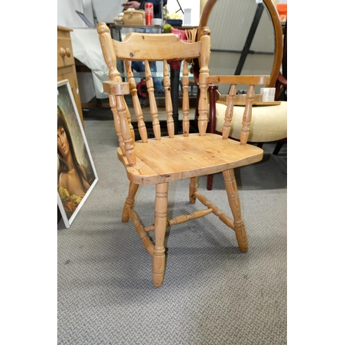 556 - A set of four pine bow back carver chairs.