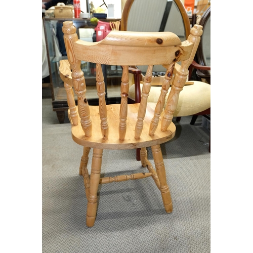 556 - A set of four pine bow back carver chairs.