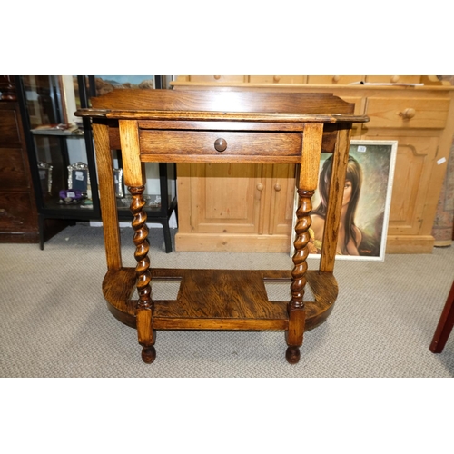 561 - An oak hall table with barley twist detail.