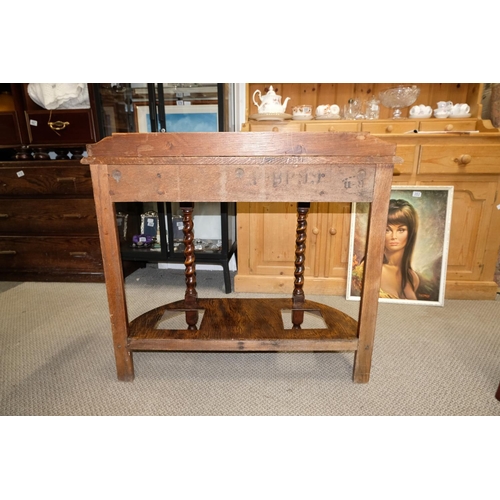 561 - An oak hall table with barley twist detail.