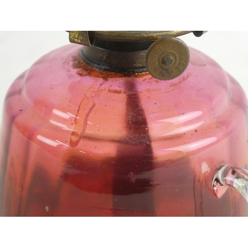 9 - An antique ruby glass finger lamp.