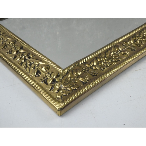 41 - A vintage gilt framed wall mirror decorated with flowers, measuring 27cm x 62cm.