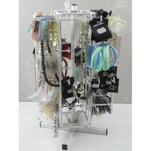 129 - A table top jewellery stand and a large quantity of new fashion jewellery.