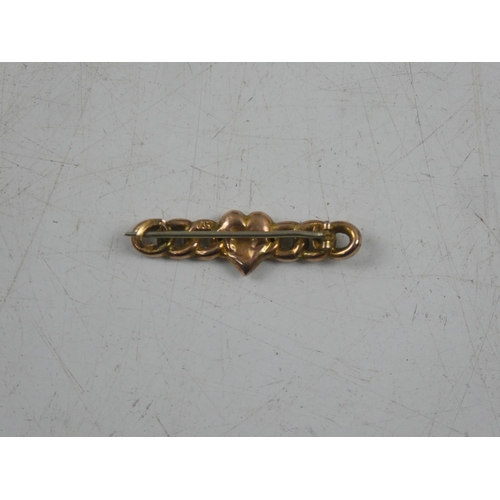 148 - A 9ct gold brooch with heart shaped detail, weighing 1.29g.