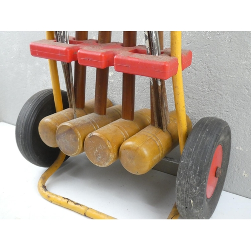 170 - A set of four vintage croquet sticks and a metal cart.