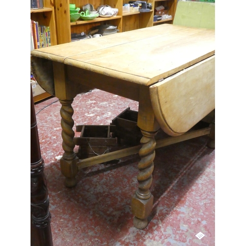 180 - An antique drop leaf table.