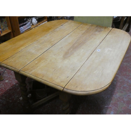 180 - An antique drop leaf table.