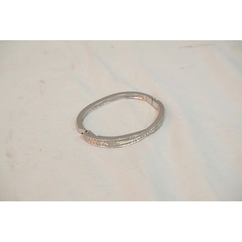 521 - A Swarovski silver bangle.