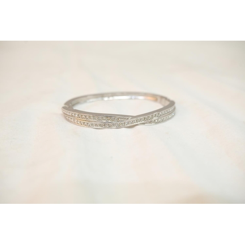 521 - A Swarovski silver bangle.