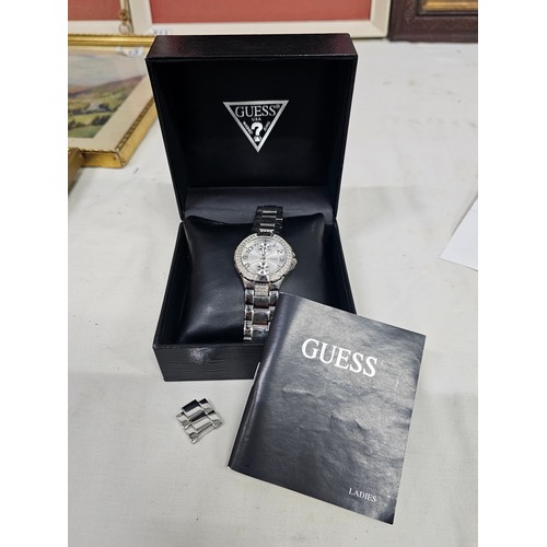 115 - A boxed Guess wristwatch.