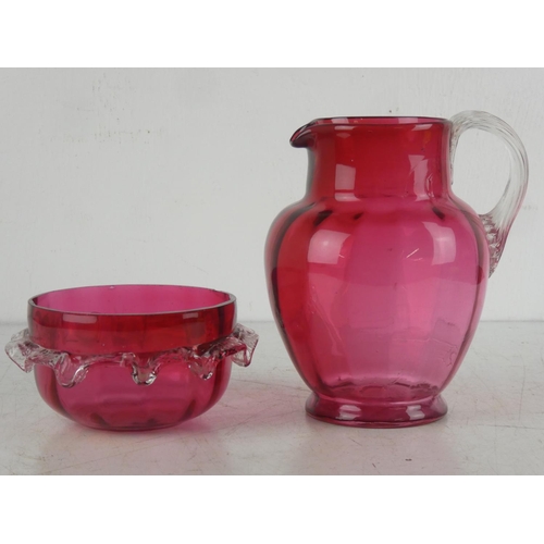 71 - An antique ruby glass jug and dish.