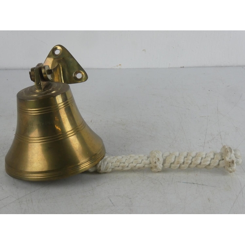 73 - A wall mounted brass bell.