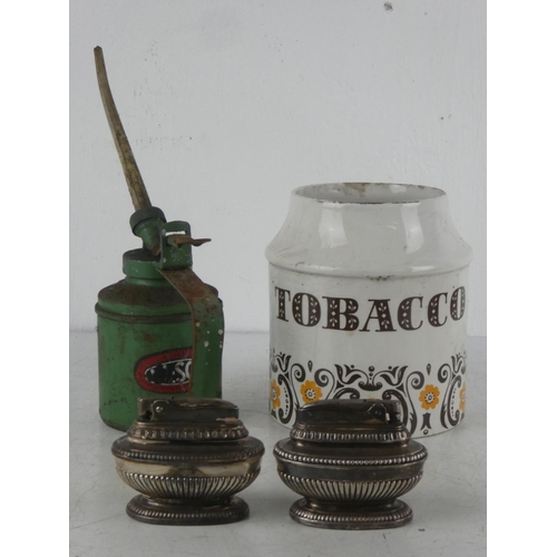 75 - A vintage ceramic Tobacco jar, a vintage Essco oil can, along with two vintage table lighters.