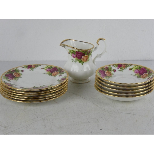 91 - A Royal Albert milk jug, five saucers and six side plates.