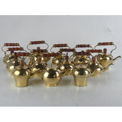 114 - A collection of 12 vintage brass kettles.