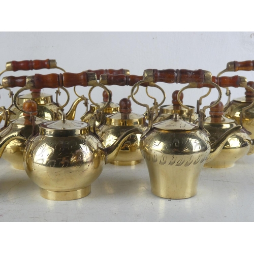 114 - A collection of 12 vintage brass kettles.