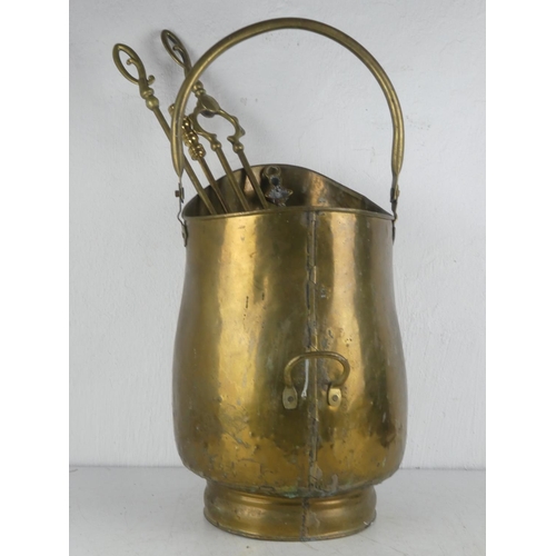 130 - An antique brass coal scuttle with fireside companion tools & toasting fork.