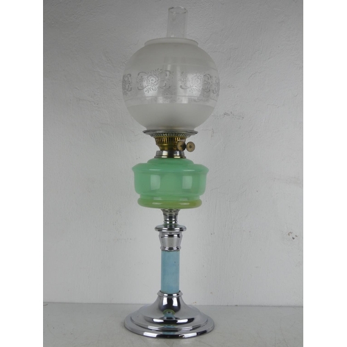 141 - A vintage oil lamp with green glass font.