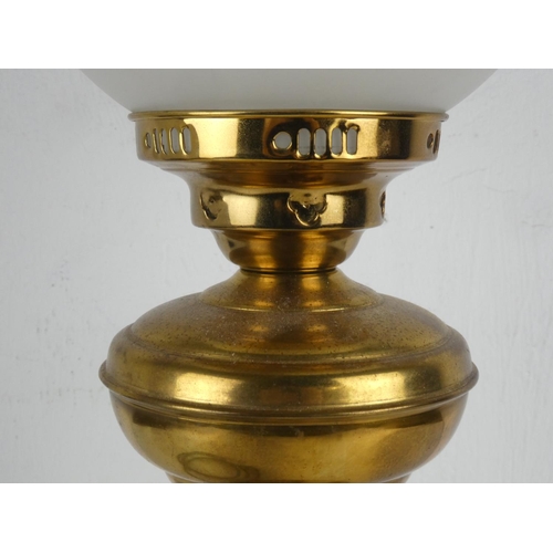 143 - An antique brass based oil lamp with etched glass shade, which has been electrified.