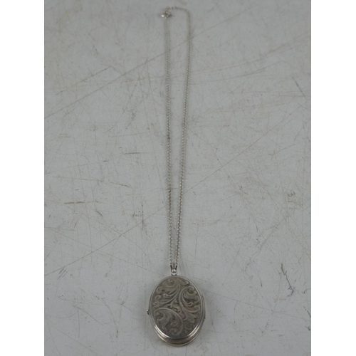 163 - A hand engraved sterling silver locket on chain.