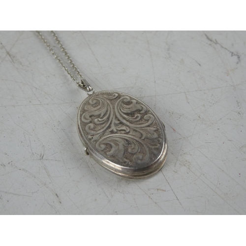 163 - A hand engraved sterling silver locket on chain.