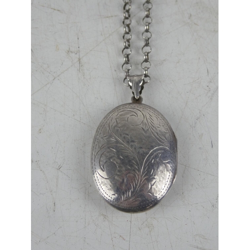 164 - A hand engraved sterling silver locket on chain.