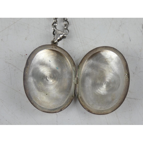 164 - A hand engraved sterling silver locket on chain.