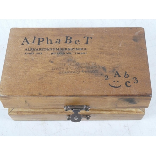 167 - A cased set of alphabet stamps.