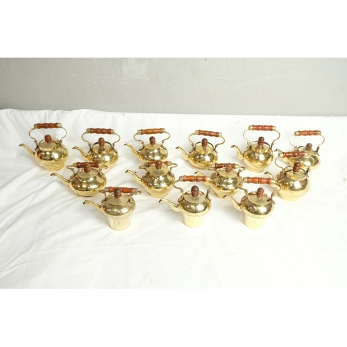 422 - A collection of vintage brass miniature kettles.