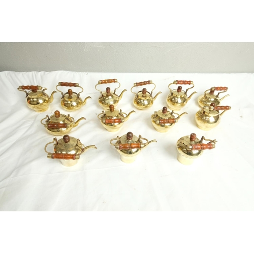 422 - A collection of vintage brass miniature kettles.