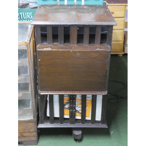 302 - A large antique oak revolving bookcase with lift up book rest (a/f).