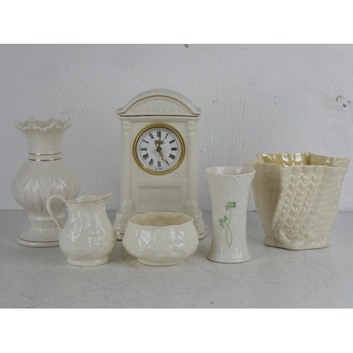 339 - A Belleek pottery mantle clock and other Belleek pottery.