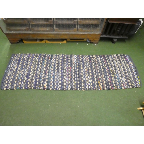 238 - A hand weaved floor rug, measuring 230cm x 72cm.