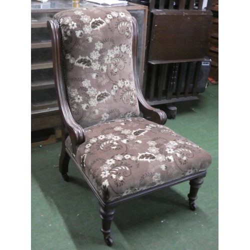 298 - An antique mahogany upholstered fireside chair.