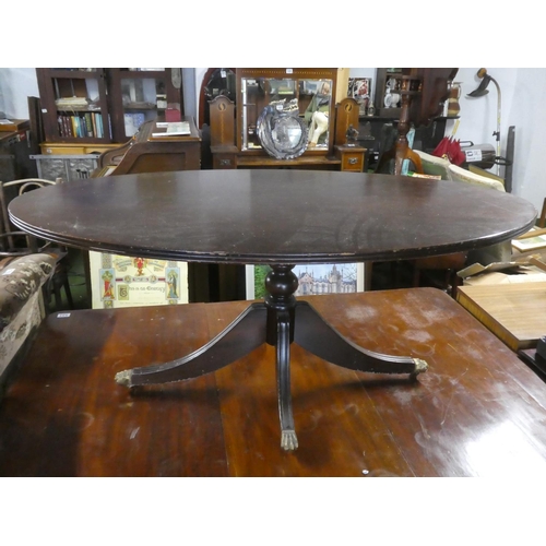 277 - A mahogany oval centre table with brass claw feet.