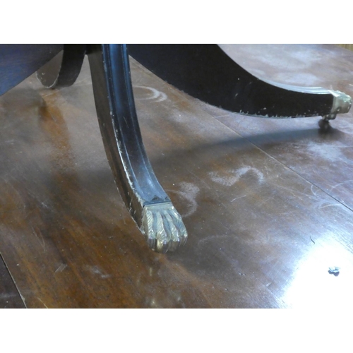 277 - A mahogany oval centre table with brass claw feet.