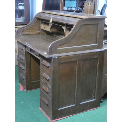 275 - A stunning antique oak roll top desk with key.