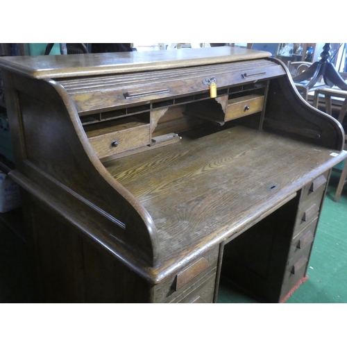 275 - A stunning antique oak roll top desk with key.