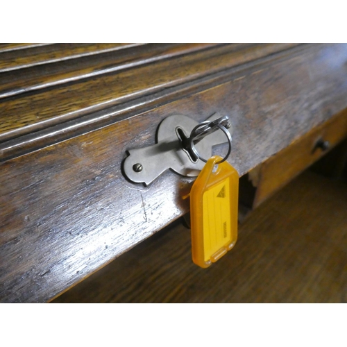 275 - A stunning antique oak roll top desk with key.